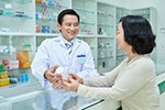 A pharmacist discusses medication with a patient.