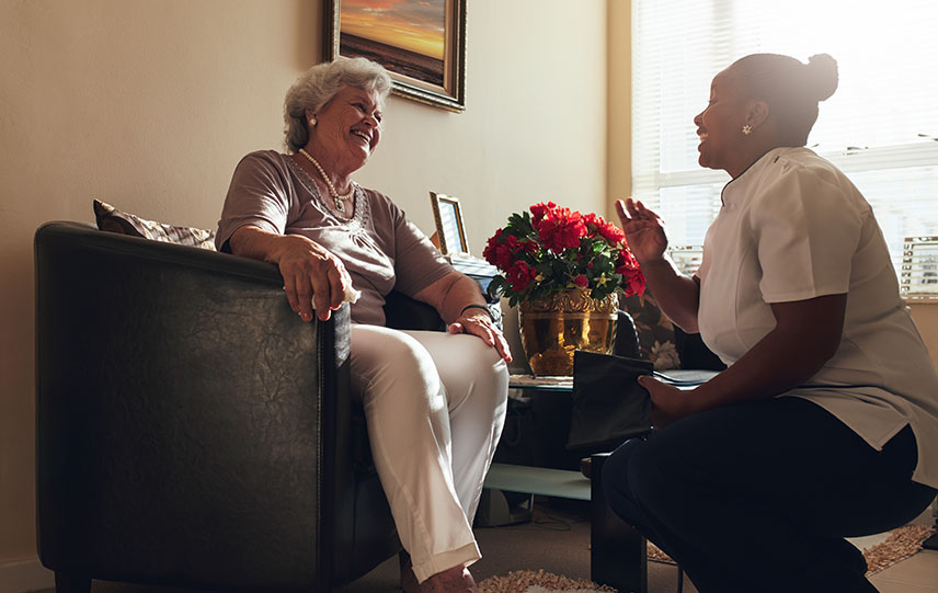 Nurse visiting senior patient home for routine checkup