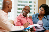 A community health worker meets with a senior couple