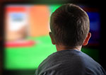 View from the back of a child's head in front of a large screen, represents behavioral interventions to prevent obesity by reducing screen time.